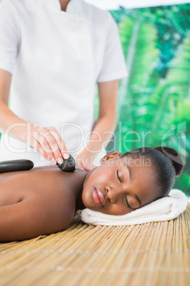 Pretty woman enjoying a hot stone massage