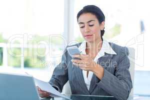 Businesswoman using her smartphone