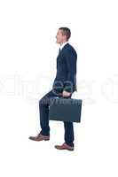 Businessman climbing with briefcase