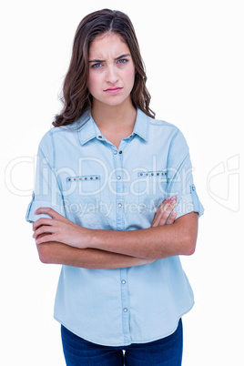Upset brunette with arms crossed looking at camera