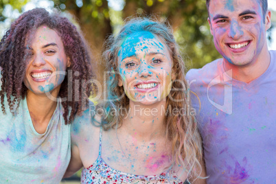 Happy friends covered in powder paint