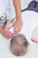 Physiotherapist doing shoulder massage to his patient
