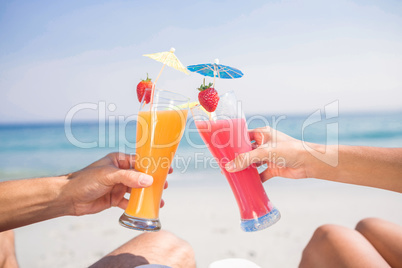 Couple toasting together at the beach