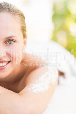 Close up portrait of a beautiful young woman on massage table