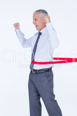 Happy businessman crossing red line