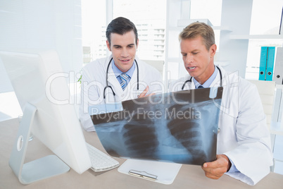 Concentrated doctors looking at Xray