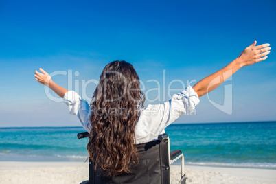 Disabled woman with arms outstretched at the beach