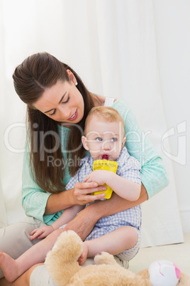 Mother giving baby a drink