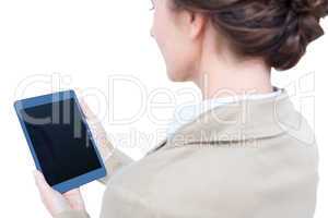 Businesswoman smiling while looking at a tablet