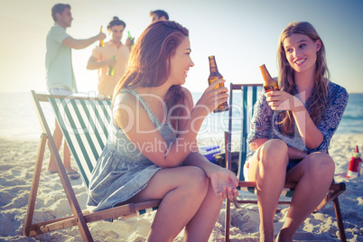 Happy friends doing barbecue and drinking beer