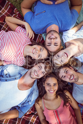 Happy friends in the park huddling in cirlce