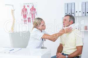 Doctor talking to patient wearing neck brace