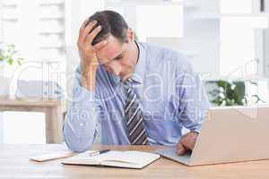 Frustrated businessman working in his office