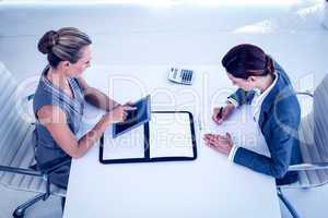 Businesswomen working together at desk