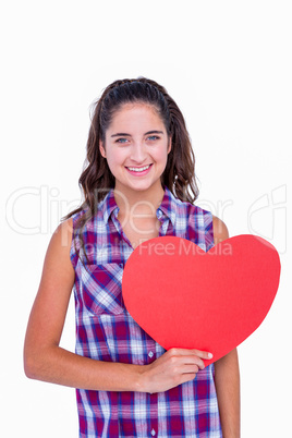 Pretty brunette holding paper heart