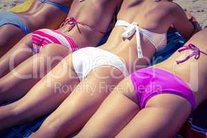 Girls in bikinis sunbathing