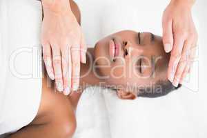 Pretty woman enjoying a reiki technique