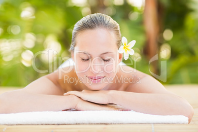 Peaceful blonde lying on towel