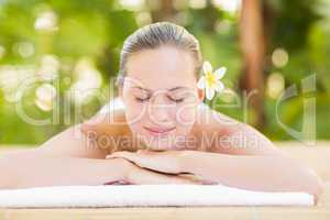 Peaceful blonde lying on towel