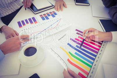 Business team analyzing bar chart graphs