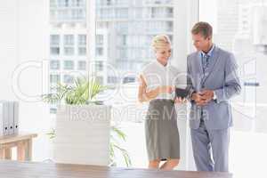 Businesswoman showing something on the tablet computer