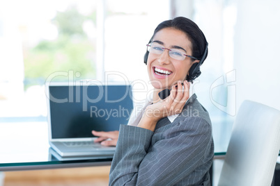 Smiling businesswoman wearing a work headset