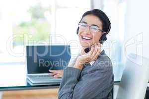 Smiling businesswoman wearing a work headset