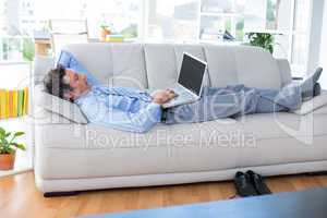 Businessman using his laptop on couch