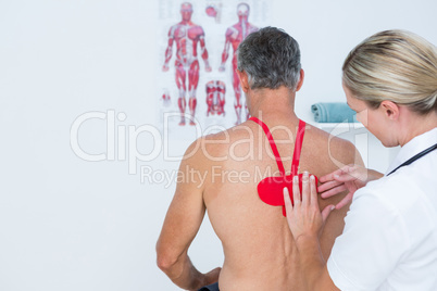 Doctor examining her patient back