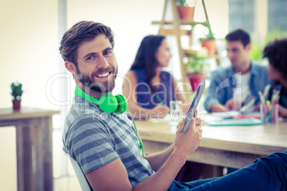 Smiling young man using digital tablet