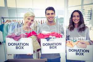 Volunteers friends holding donation boxes