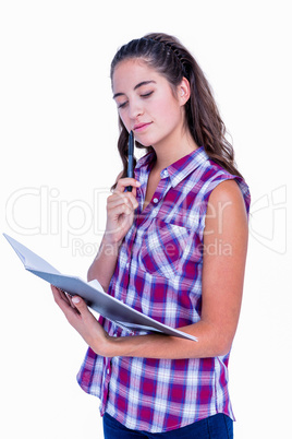 Pretty brunette looking at notebook