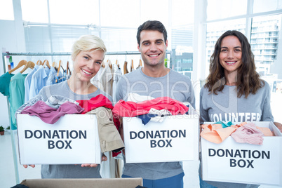 Volunteers friends holding donation boxes