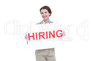 Businesswoman holding a hiring sign