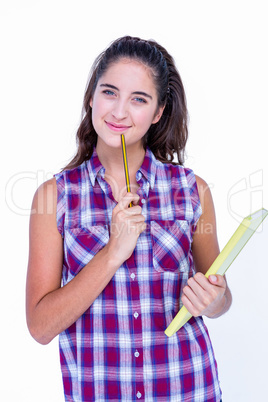 Pretty brunette looking at camera and holding notebook