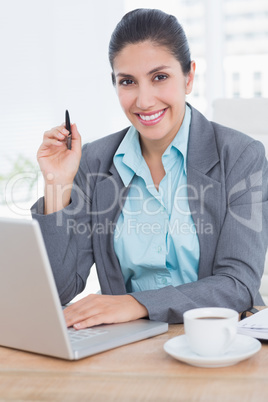 Smiling businesswoman using her computer