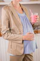 Blonde pregnancy drinking a smoothie