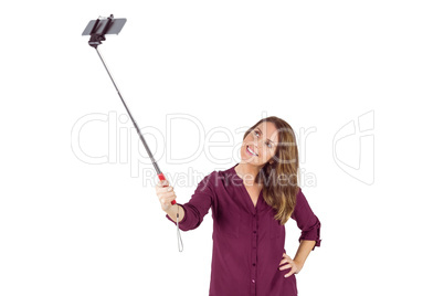 Pretty woman using a selfie stick