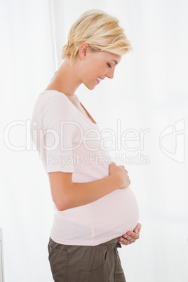 Smiling of a blonde pregnant