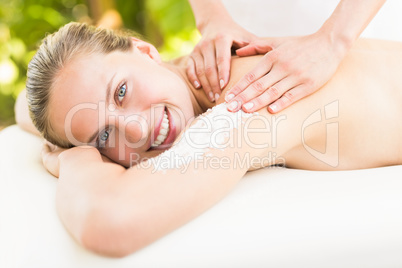 Attractive young woman receiving shoulder massage