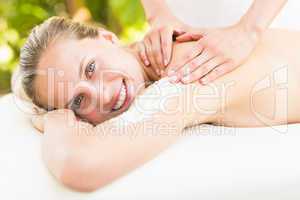 Attractive young woman receiving shoulder massage