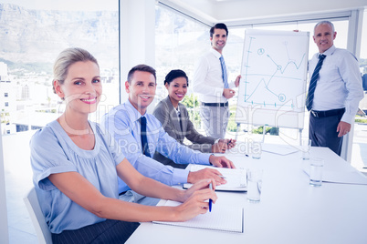 Business team during meeting smiling at camera