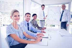 Business team during meeting smiling at camera