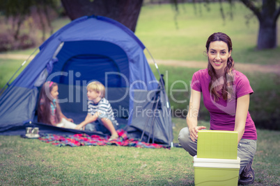 Mother and children camping in the park