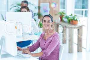 Portrait of businesswoman using computer