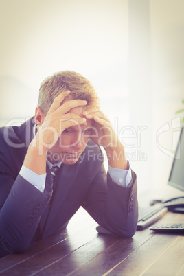 Irritated businessman looking his desk