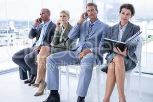 Business people waiting to be called into interview