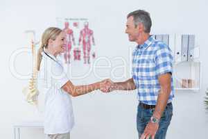 Patient shaking hands with doctor