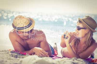 Cute couple tacking photos on the beach
