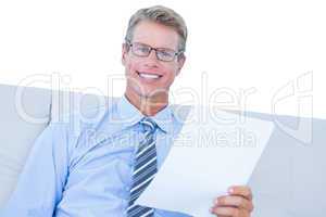 Businessman reading document at his desk